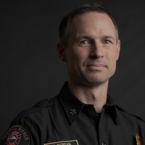 A man in a dark uniform with insignia and a 